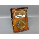 Vintage leather cased travelling clock with perpetual calendar, 6" long