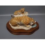 Unboxed with certificate Wild Tracks, model as a tiger and tiger cub on a teak plinth