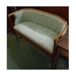 Edwardian mahogany two seater cottage sofa, in the Macintosh style, with green floral upholstered