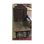 19th century oak hall chair, with heavily carved floral seat and back with inset panel of urn of