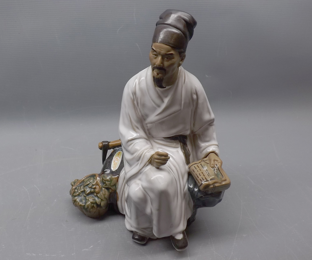 20th century Oriental seated figure of a doctor, 10" tall