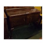 20th century walnut shape fronted sideboard, fitted centrally with two serpentined cupboard doors,