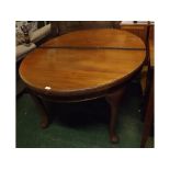 19th century mahogany oval extending dining table supported on four pad feet with porcelain