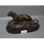 Reproduction bronzed metal study of a reclining lion after Barye, 9" long