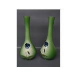 Pair of Ault green glass vases, with blue floral detailing, 13 ins high