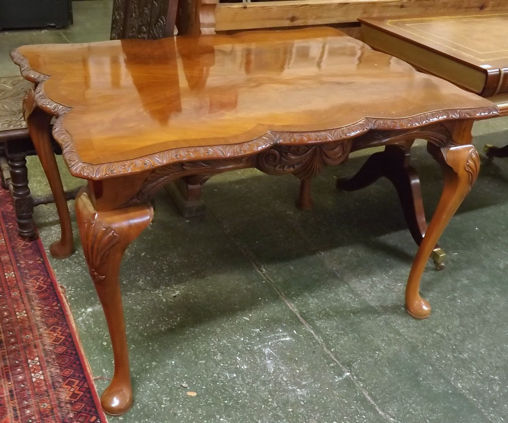Reproduction mahogany rectangular dining table, with shaped edge and carved frieze, supported on
