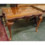 Reproduction mahogany rectangular dining table, with shaped edge and carved frieze, supported on