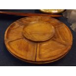 20th century teak circular revolving Lazy Susan, with seven sections and central bowl, 18 1/2 ins