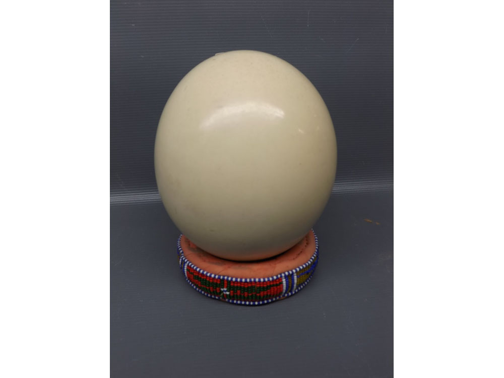 An ostrich egg on a beaded plushwork stand