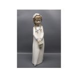 Spanish made figure of a young girl with pigtails and blue ribbons, holding a basket, 10" tall