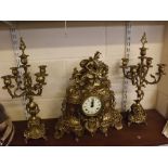 20th century brass clock garniture, with heavily cast scrolling detail with a mounted classical