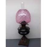 Victorian oil lamp with dimpled cranberry shade, 23 high