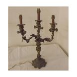 Gilt metal rococo style two branch electrified candelabrum, pair of wall sconces and three branch