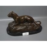 Reproduction bronzed metal study of a reclining lion after Barye, 9 long