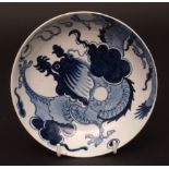 A Lowestoft saucer dish c1770 painted in tones of light and dark blue with the dragon pattern