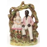 19th century Staffordshire bocage group of "Uncle Tom and Eva" painted in colours throughout, 6 1/