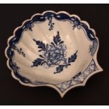 A Lowestoft pickle dish c1770 of scallop shape painted with a floral spray within a scroll and