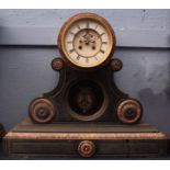 Late 19th century French black and variegated rouge marble mantel clock, the drum shaped case on