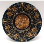 Early 20th century Austrian Majolica style charger, the border embossed with Bacchanalian masks,