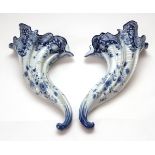 Pair of late 19th century Dutch Delft wall pockets of curved scroll form, typically painted in