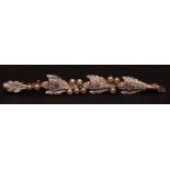Early 20th century precious metal and diamond seed pearl bar brooch, the textured feather design set