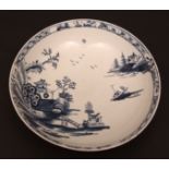 A Lowestoft saucer dish c1768 well painted with an island and Chinese river scenes within a