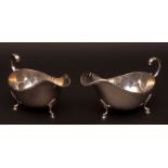 Two Elizabeth II gravy boats, each of polished form with cast and applied gadrooned borders and leaf