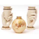 Pair of Royal Worcester vases, the supports modelled as clutching hands and the wrists decorated
