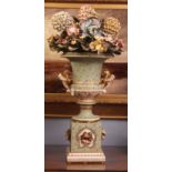 Campana shaped ornamental urn decorated with spreading flowers and applied on either side with