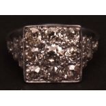 Precious metal diamond cluster ring, the square panel set with nine brilliant cut diamonds, having