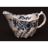A Lowestoft cream boat c1775 of low Chelsea ewer shape decorated with trailing flowers with an