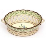 English Creamware chestnut basket of oval form with lattice pierced border, decorated in a green and