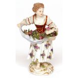 Small Meissen figure of female flower seller painted in colours throughout, crossed swords mark in