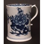 An early Lowestoft mug c1762 the tapered body painted in dark blue with flowers and foliage with a