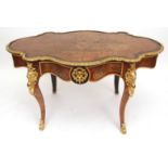 19th century red Boulle bureau plat of oval form, with gilt metal moulded surround and frieze fitted