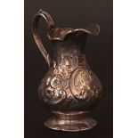 Victorian milk jug, of baluster form with applied and flared rim and scrolling handle on spreading