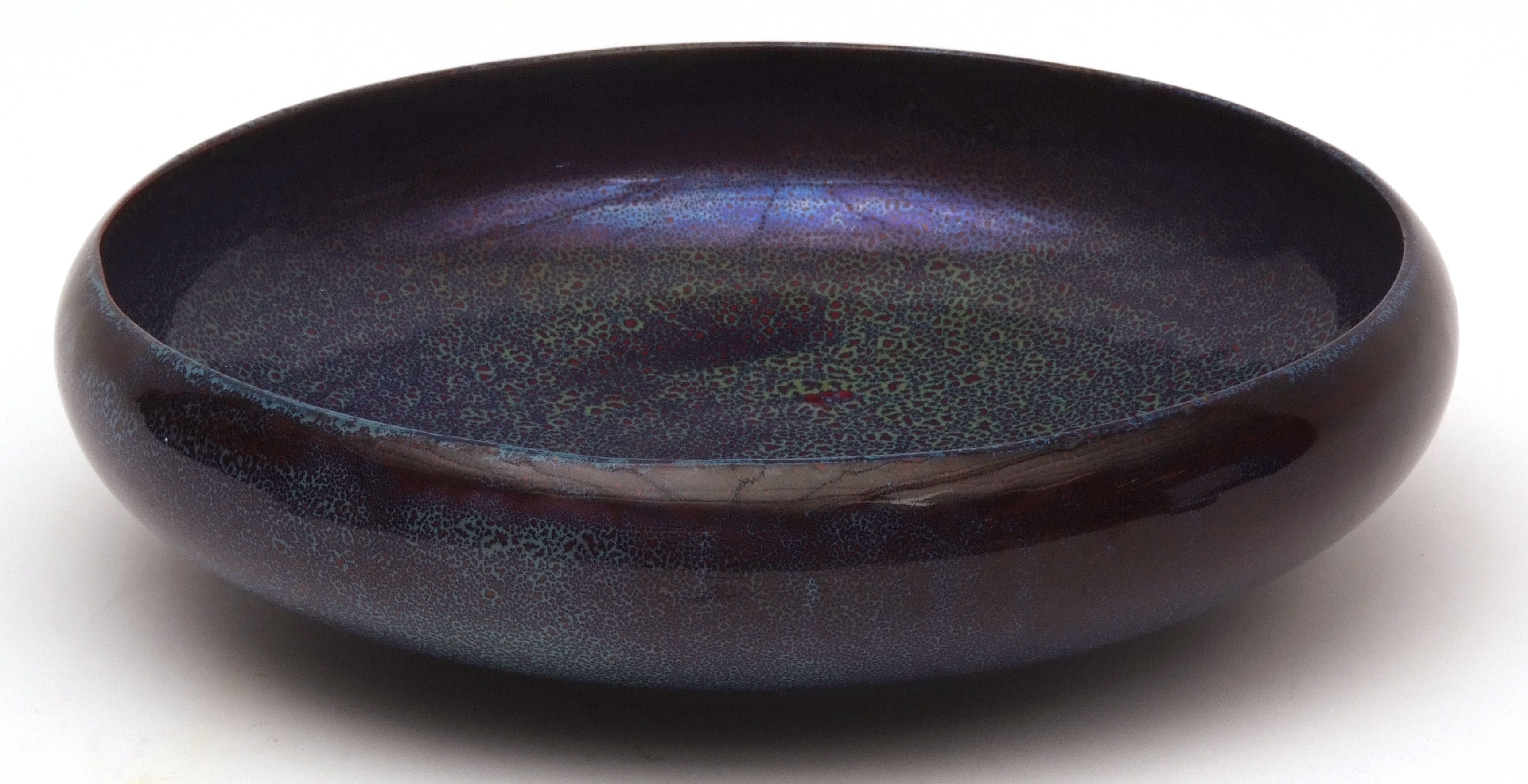 Royal Doulton circular bowl of compressed form, decorated with a mottled blue/flamb speckled design,