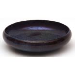 Royal Doulton circular bowl of compressed form, decorated with a mottled blue/flamb speckled design,