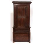 17th century and later oak small settle/bacon cabinet, moulded top over a four panelled door