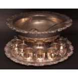 Large electro-plated punch bowl together with a polished and chased circular tray, ladle and 12
