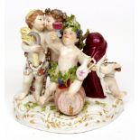 Meissen group of four Bacchanalian putti painted in colours throughout, crossed swords mark in