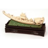 Chinese ivory carving of the lucky gods aboard a dragon pleasure boat set upon a green stained