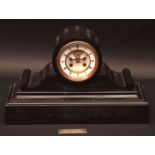 Late 19th century French black slate mantel clock, the drum shaped case on scrolling supports to a