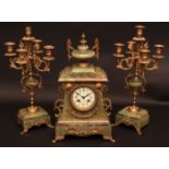 Early 20th century French green onyx and gilt highlighted clock garniture, Chavot, the case with