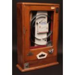 Mid-20th century oak cased and coin-operated cigarette dispensing game, plain case with hinged and