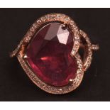 Modern yellow metal ruby and diamond ring, the heart-shaped facetted ruby (5.30ct approx), claw