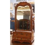 Early 18th century walnut toilet mirror, moulded top on two plain uprights crested with gilt metal