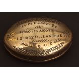 Oval brass snuff box, the hinged cover with stamped decoration and presentation inscription "A