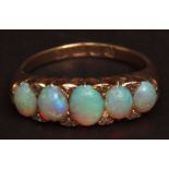 Victorian 18ct gold opal and diamond ring, the five graduated oval cut opals accented with eight