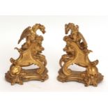 Pair of 19th century ornate gilt metal andirons, formed as winged dragons riding on the back of